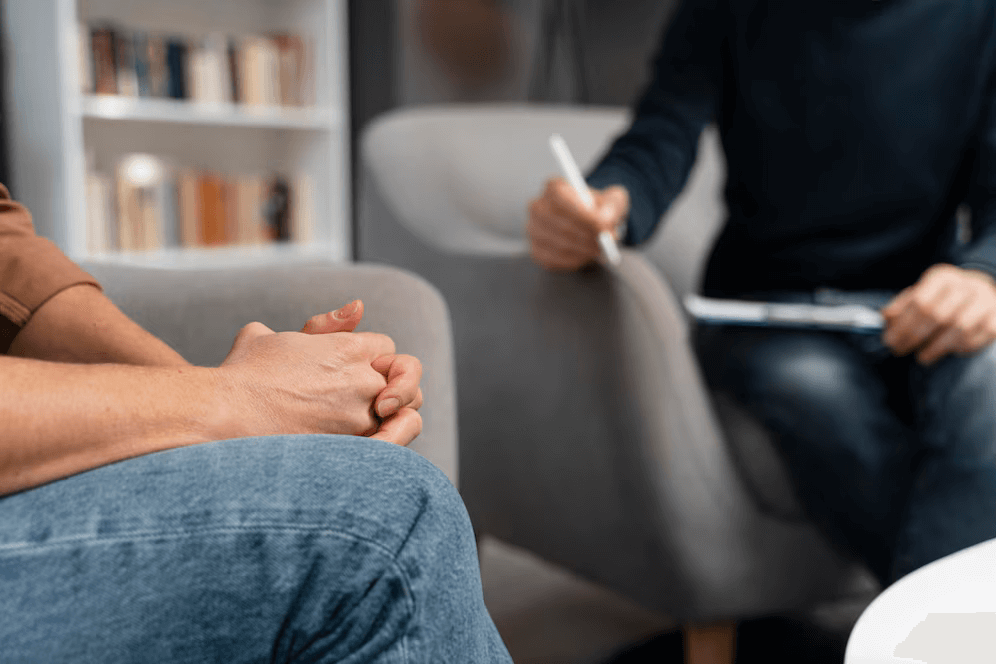 woman-with-hands-together-talking-with-counselor